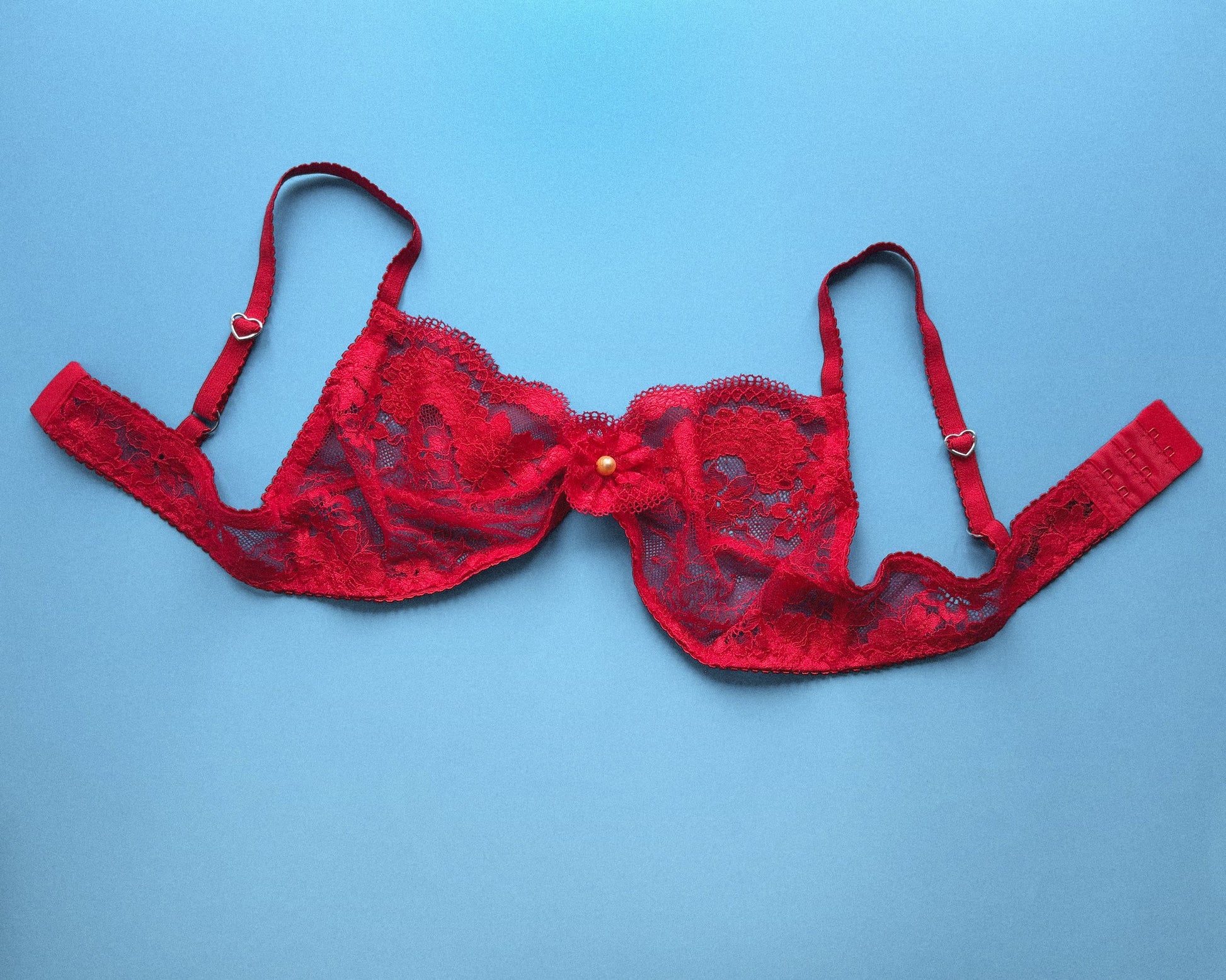 Red lace bra on a blue background