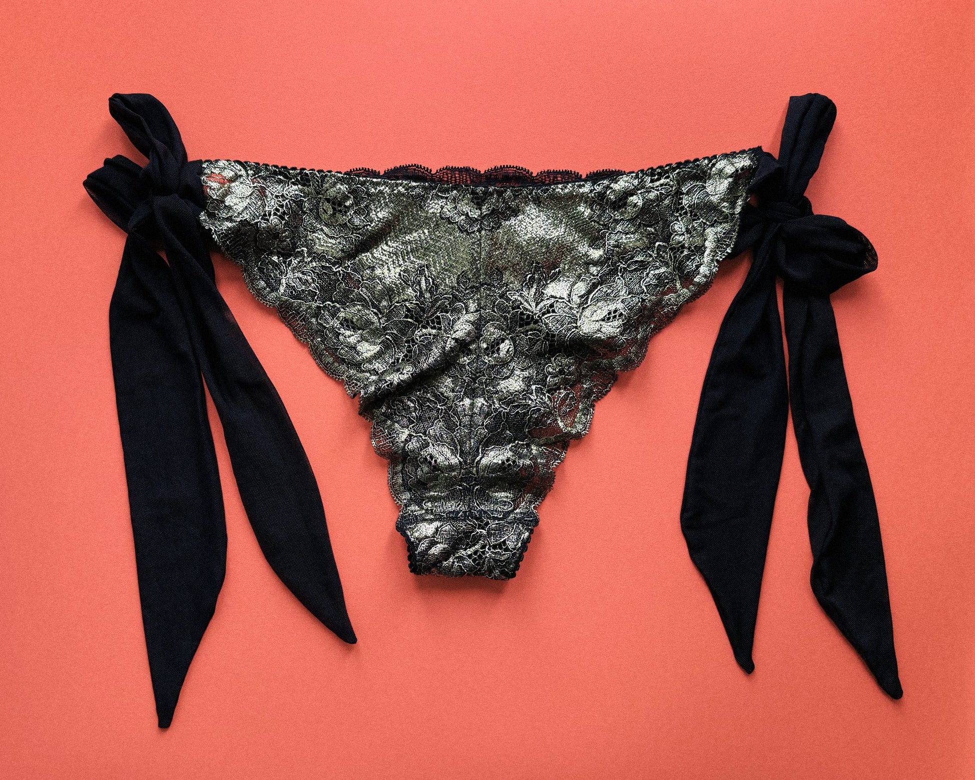 Black and gold lingerie slip with black mesh side bows.