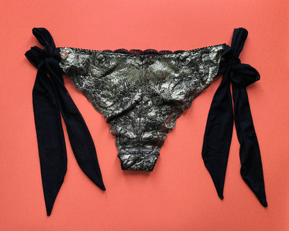 Black and gold lingerie slip with black mesh side bows.