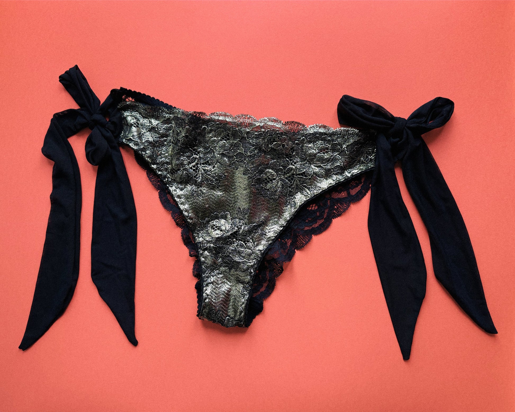 Black and gold lingerie slip with black mesh side bows.