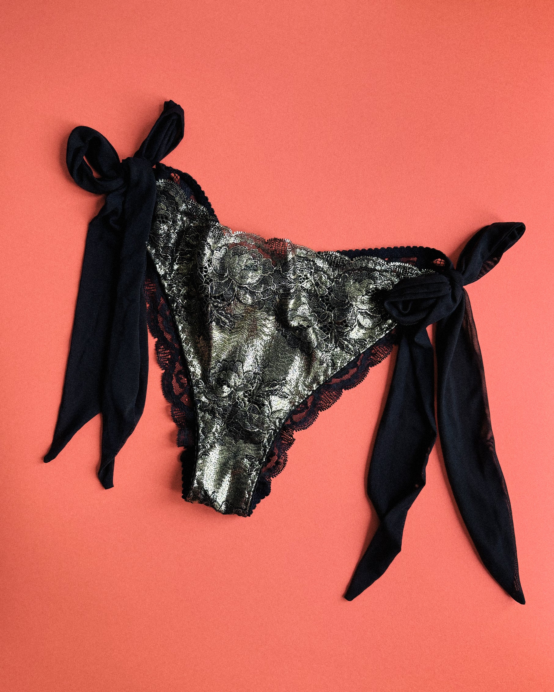 Black and gold lingerie slip with black mesh side bows.