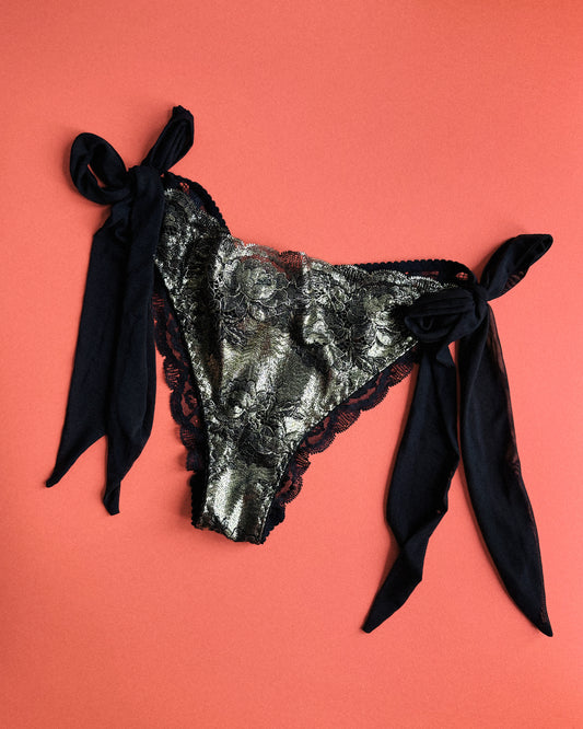 Black and gold lingerie slip with black mesh side bows.
